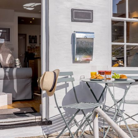 Chairs and table outside at the front of Tegfan holiday cottage in Aberdyfi