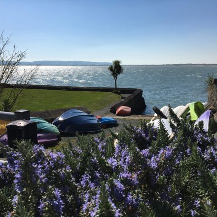 Small boats and canoes on the shore in Aberdyfi